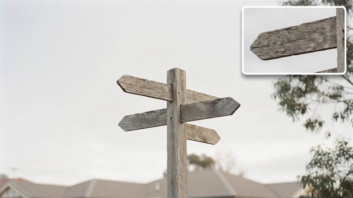 A signpost with several arms against an open sky, seen from below.